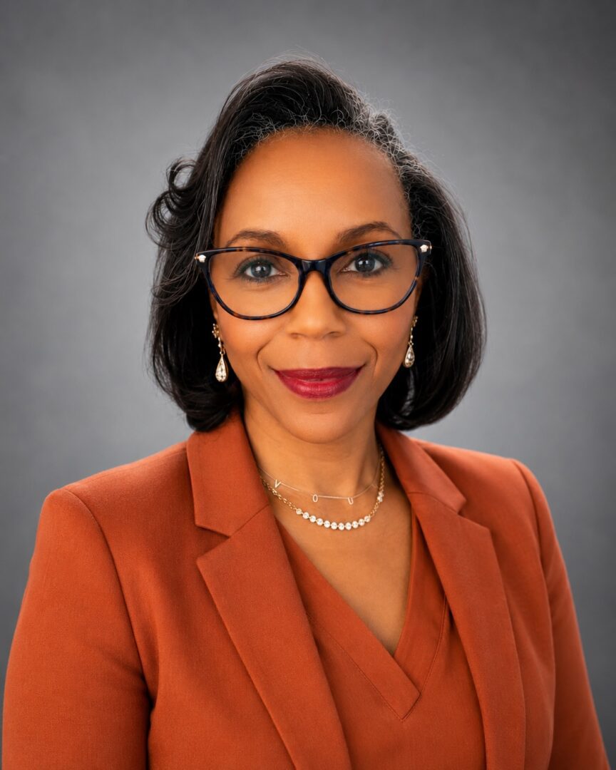 Dr. Jeannelle Perkins - Rust Orange Jacket